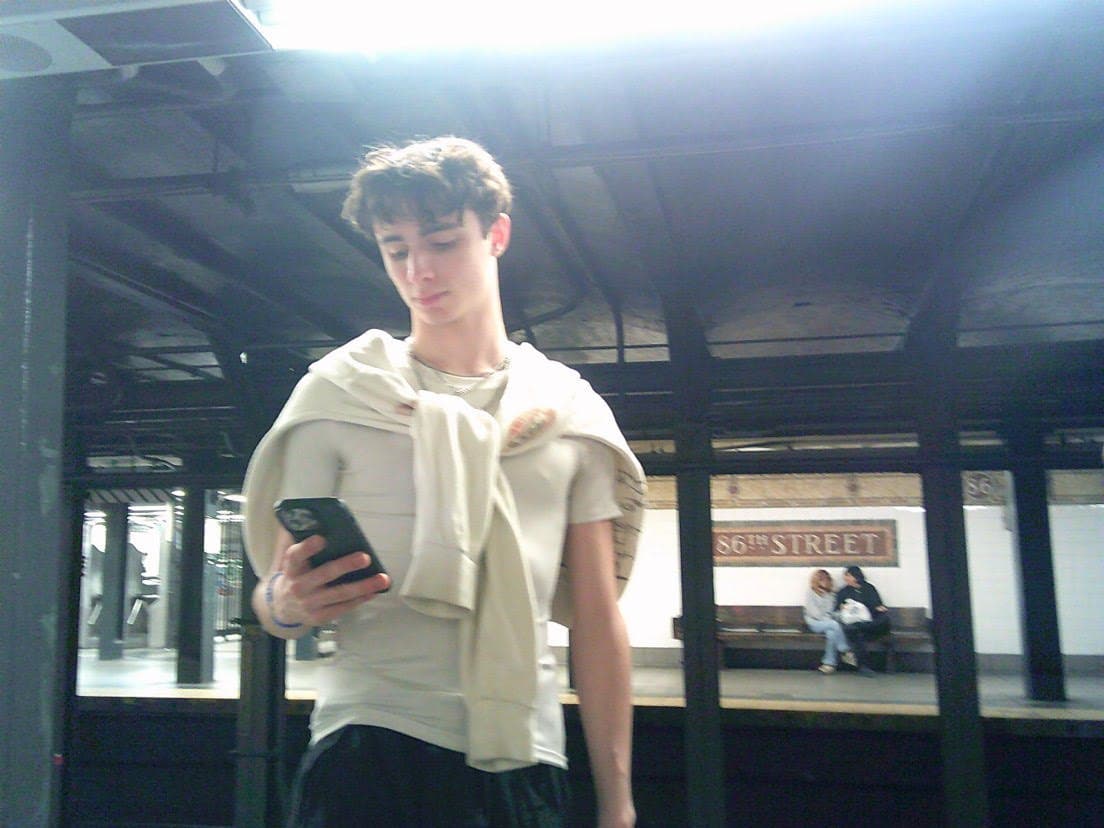 Charlie on a subway platform, towel over one shoulder