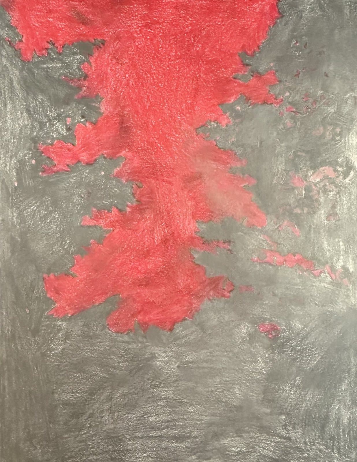 A jagged red sky spreading down through grey masses of forest.